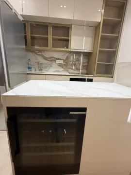 Modern kitchen with an island and built-in appliances. - image 10