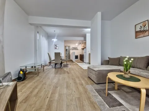 Spacious living room with a sofa set, dining area, and kitchen in the background. - image 7