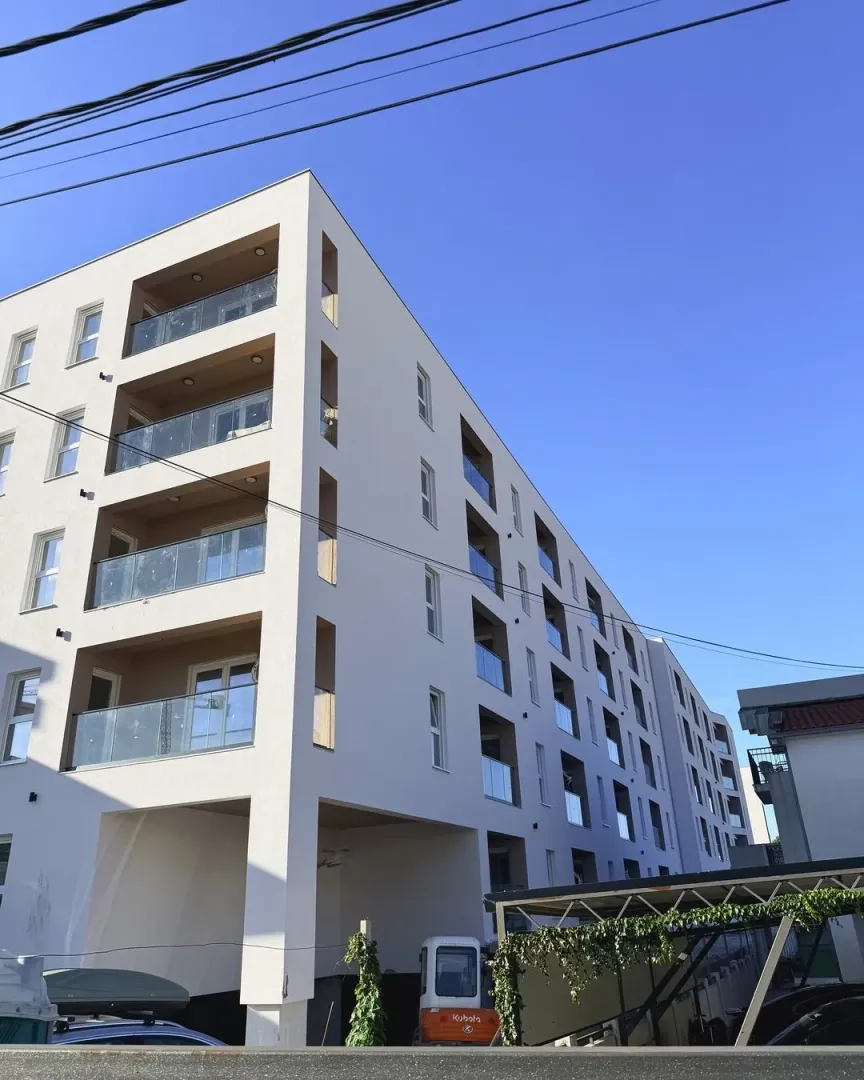 Exterior view of a modern residential building with balconies.
