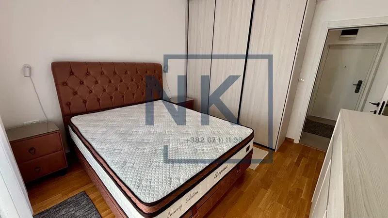 Furnished bedroom with a double bed, wardrobe, and nightstands.