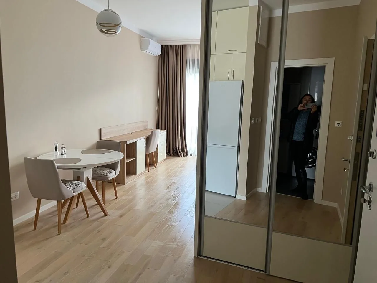 Living room with dining area and hallway wardrobe.