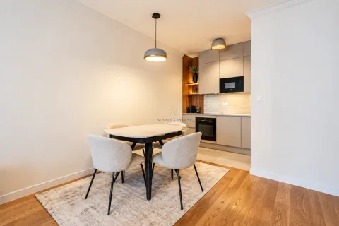 Modern kitchen with a dining table and chairs. - image 4