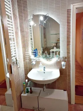 Small bathroom with a sink, mirror, and tiles. - image 15