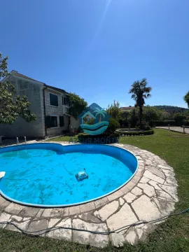 Exterior of the house with a swimming pool and landscaped yard. - image 2