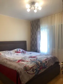 Bedroom with a double bed and curtains. - image 13