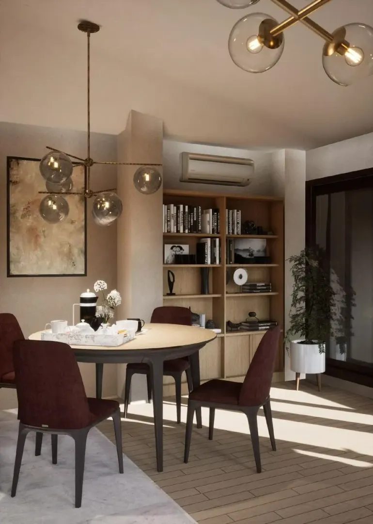 Dining area with a round table, burgundy chairs, and built-in bookshelves.