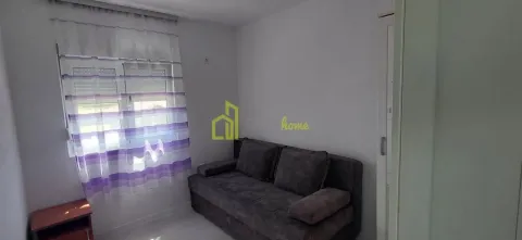 Small living room with a sofa and a window with purple curtains. - image 7