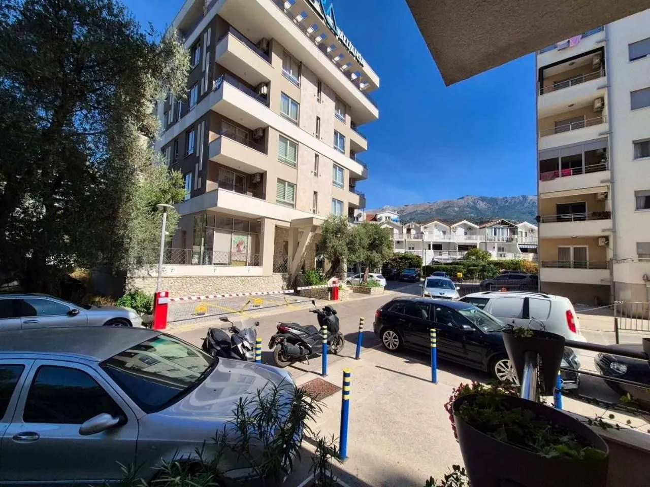 View from the terrace facing the building, courtyard, and surrounding structures.
