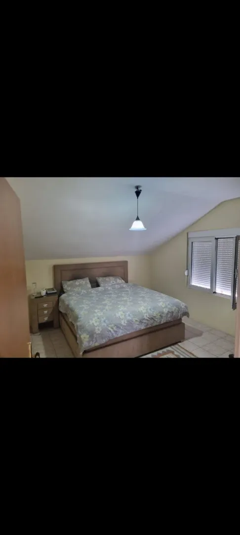 A bedroom with a large double bed.