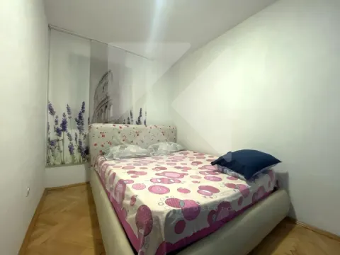 Smaller bedroom with a double bed and decorative wall motifs. - image 9
