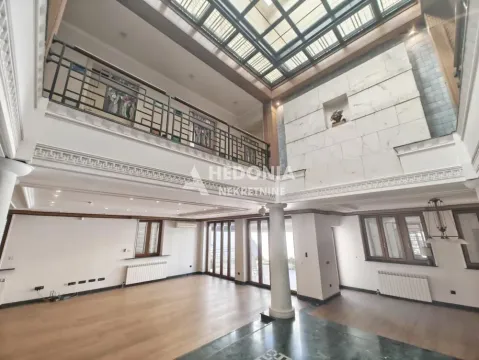 Spacious living room with a gallery and a large skylight. - image 5