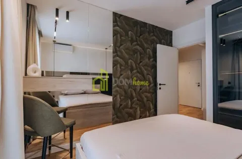 Modern bedroom equipped with a double bed and mirrors. - image 6