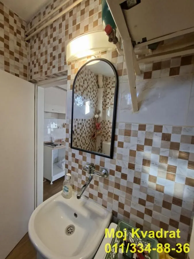 Small bathroom with a sink and a mirror.