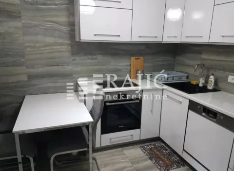 Modern white kitchen with a dining table and grey wall tiles. - image 4