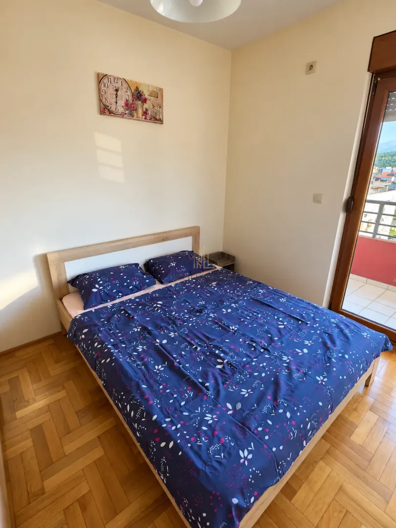 Spavaća soba sa bračnim krevetom i izlazom na terasu.
