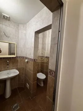 Smaller tiled bathroom with a sink and a toilet. - image 9