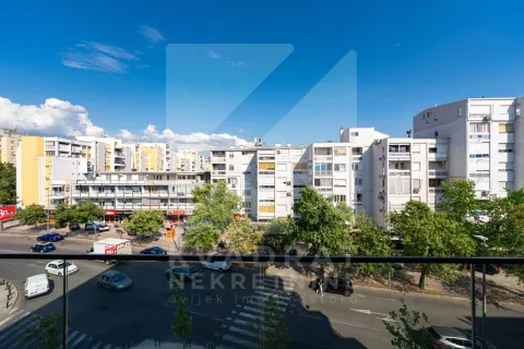 View from the terrace towards the city streets and surrounding buildings. - image 22