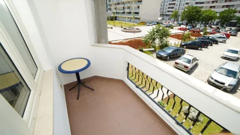 A balcony with a small table and a view of the surroundings. - image 6