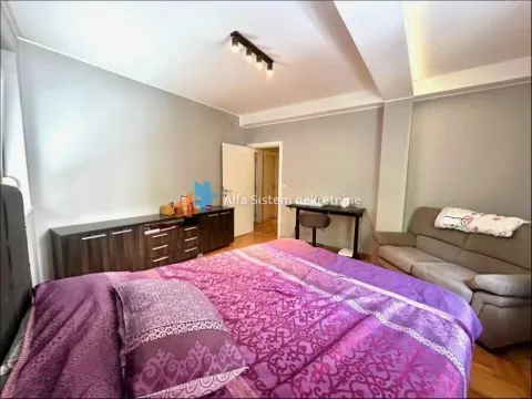 Bedroom with a large double bed, sofa, and chest of drawers. - image 12