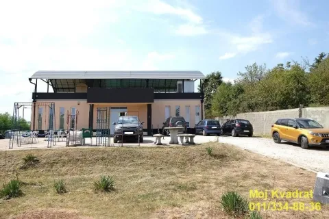 Exterior view of the building with yard and parking. - image 16