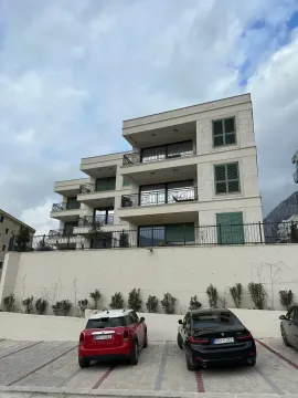 Exterior view of a modern residential building with terraces and a parking area in the yard. - image 2