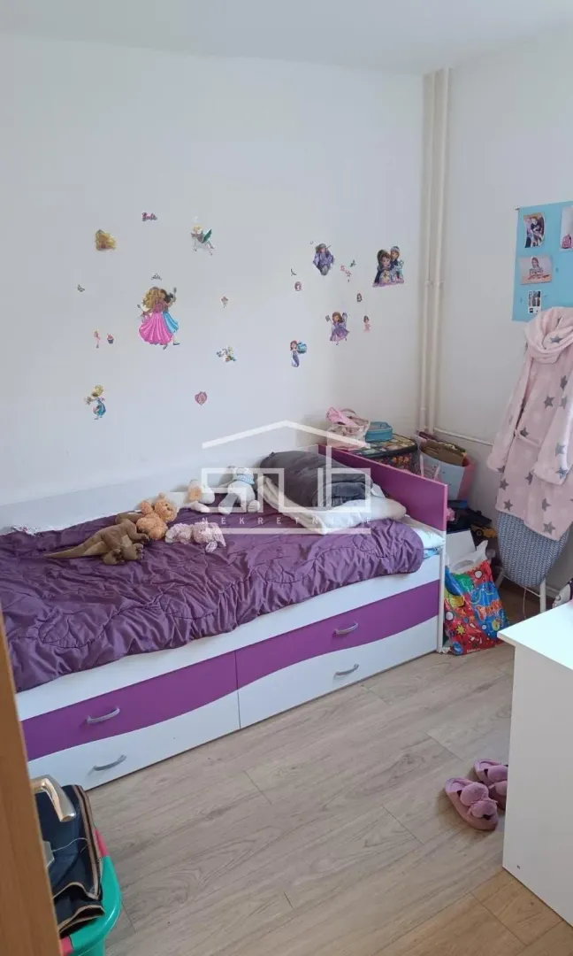 Children's bedroom with a bed and wall stickers.