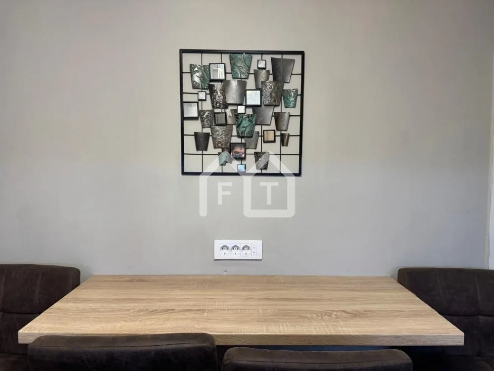 Dining table with chairs and wall decoration.