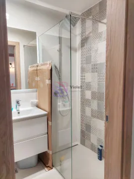 Modern bathroom with a shower cabin and a sink. - image 12
