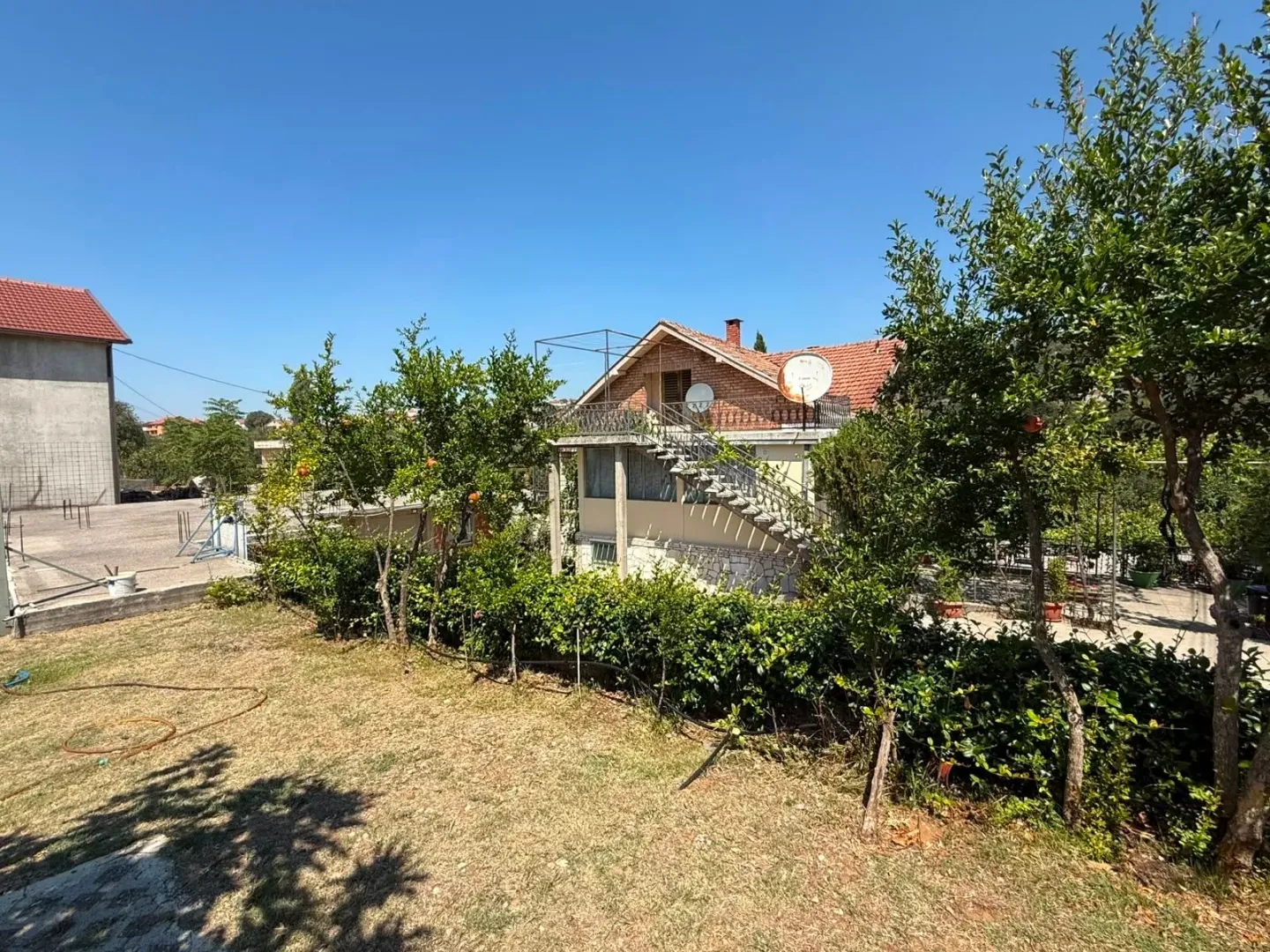 View of the yard and the exterior of the house with greenery.