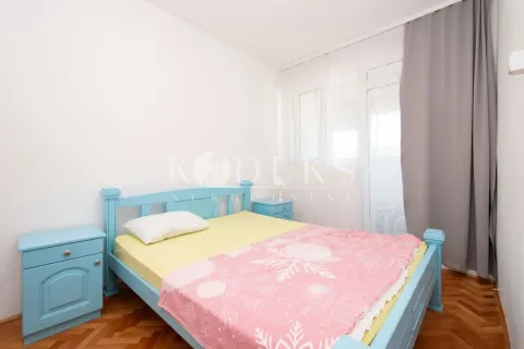 Bedroom with a blue bed and nightstands. - image 2