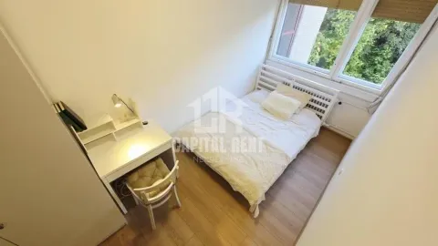 Smaller bedroom with a bed and a desk. - image 5