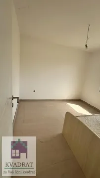 Empty room with ceramic floor tiles and part of a bed. - image 15
