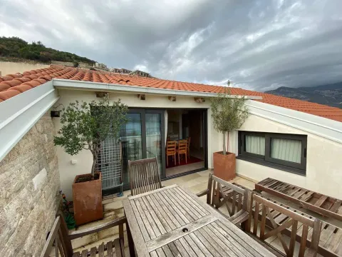 Roof terrace with outdoor seating and a view of the hills and rooftops. - image 9