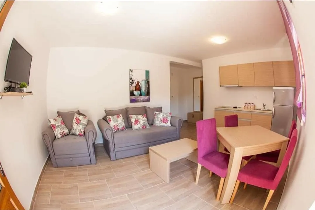 Living room with a dining area and kitchen in an open space.