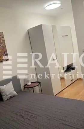 Furnished bedroom with a large wardrobe and a double bed.