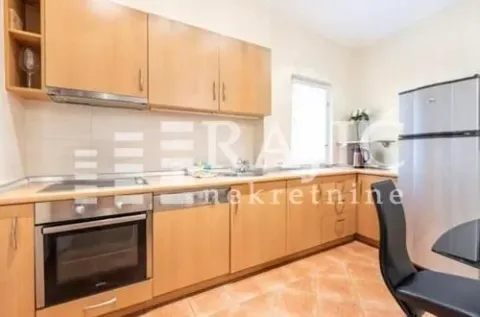 Fitted kitchen with wooden cabinetry and built-in appliances. - image 5