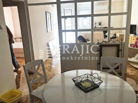 View of the living room section with a dining table and a glass partition. - image 13