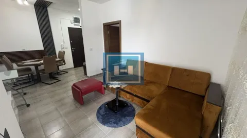 Living room with a sectional sofa, a coffee table, and a dining area in the background. - image 4