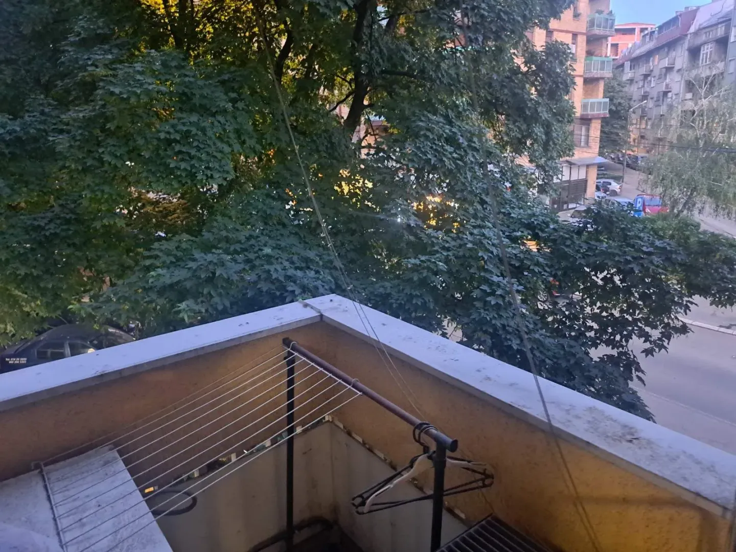 View from the terrace overlooking surrounding greenery and buildings.