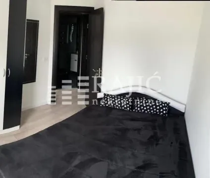 Bedroom with a large double bed and wardrobe. - image 7