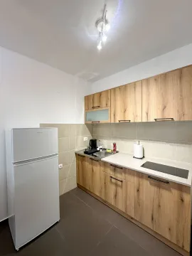 Small kitchen with wooden cabinetry and a white refrigerator. - image 3