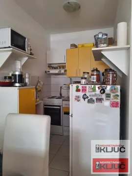 Manja kuhinja sa belim i žutim elementima, šporetom i frižiderom. - image 6