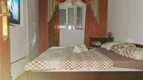 Furnished bedroom with a double bed. - image 5