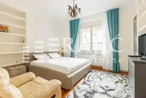 Furnished bedroom with a double bed, shelving units, and a large window. - image 8
