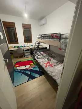 Children's bedroom with a bunk bed and a desk. - image 5