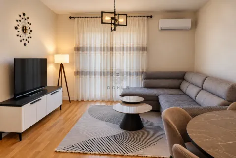 Living room with a sectional sofa, television, and dining table. - image 2