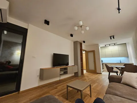 Living room connected with dining area and kitchen in a modern apartment. - image 5