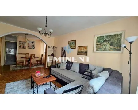 Living room with a corner sofa, coffee table and a view towards the dining area. - image 3