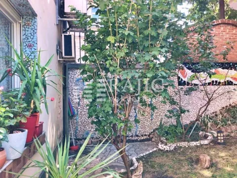 Landscaped yard with greenery and a paved area. - image 6