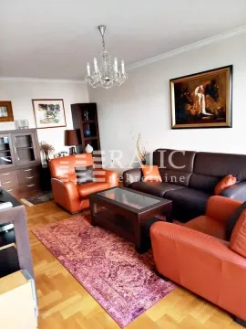 Living room furnished with seating sets, a coffee table, and cabinetry. - image 3